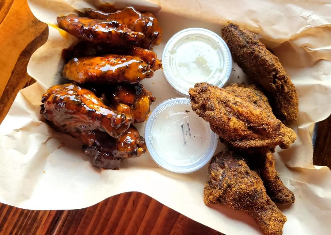 two flavors of chicken wings with cups of ranch