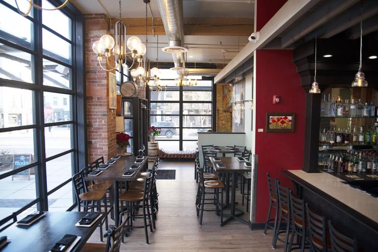 tables and empty chairs inside a restaurant