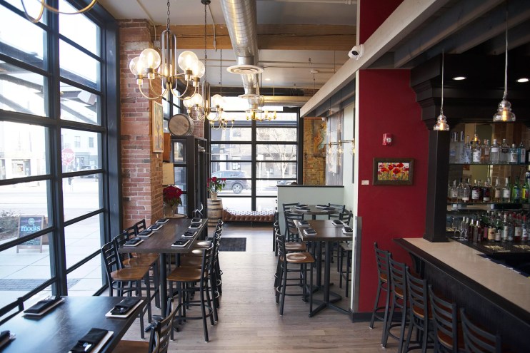 tables and empty chairs inside a restaurant