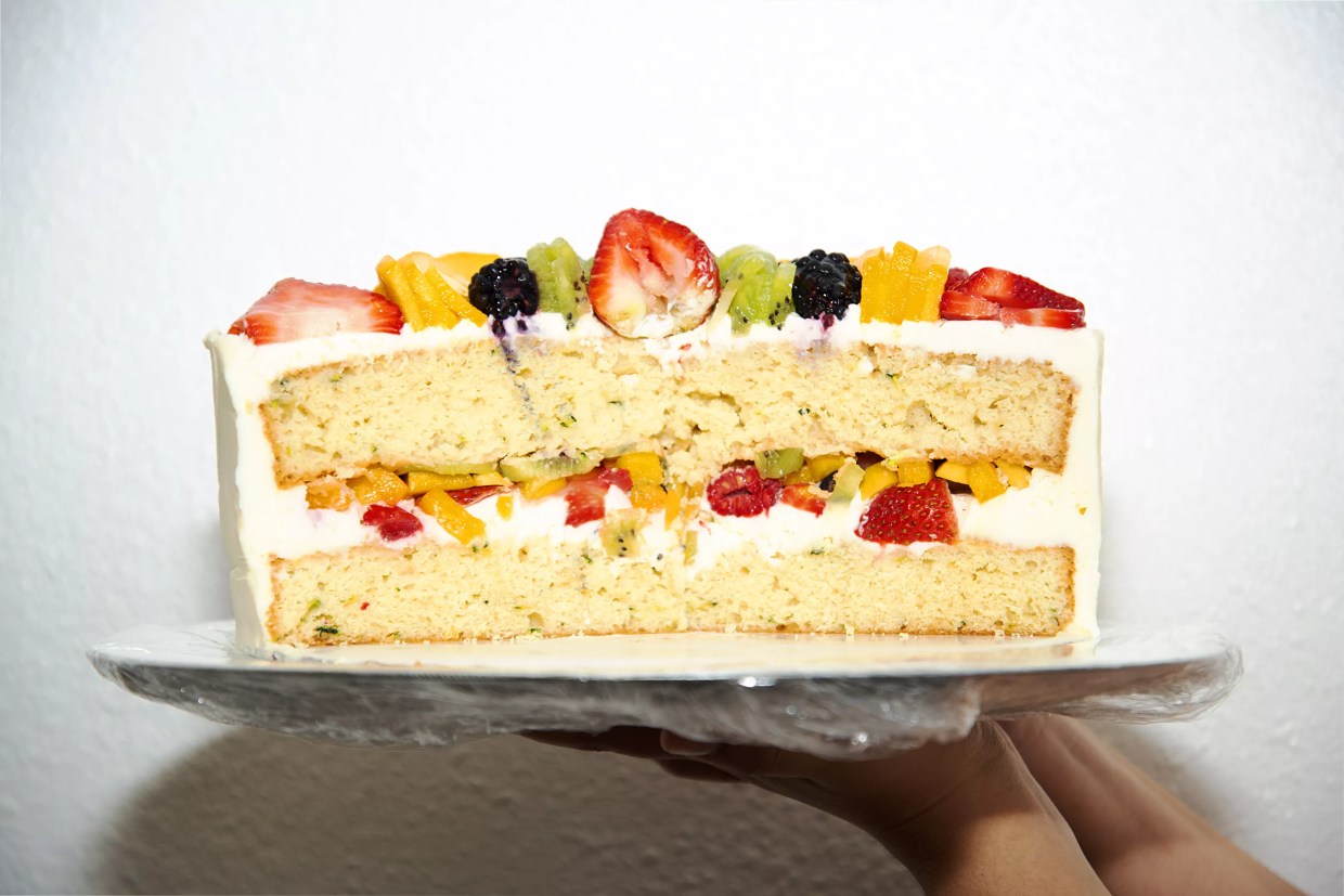 a white cake with fruit