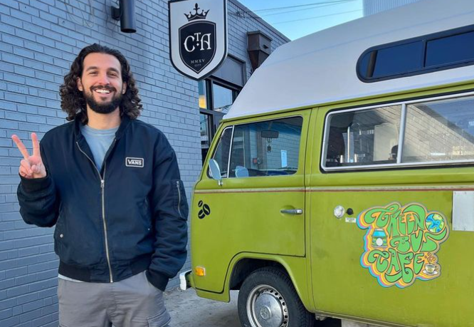 a man standing next to a lime green VW bus