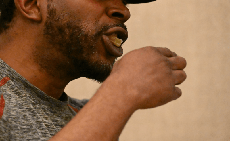 A Denver man eats a marijuana edible during a CDOT event in Colorado.