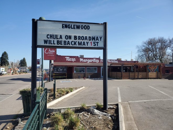 a sign in front of a restaurant