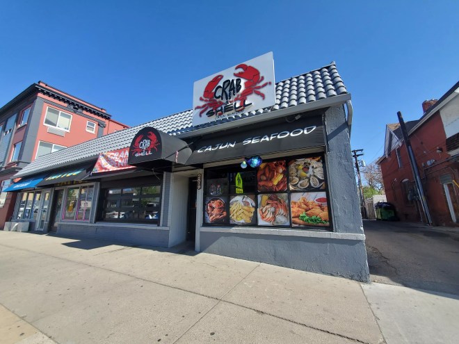 the front of a restaurant with a big crab on the sign