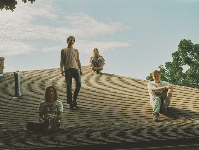 four men on a hill