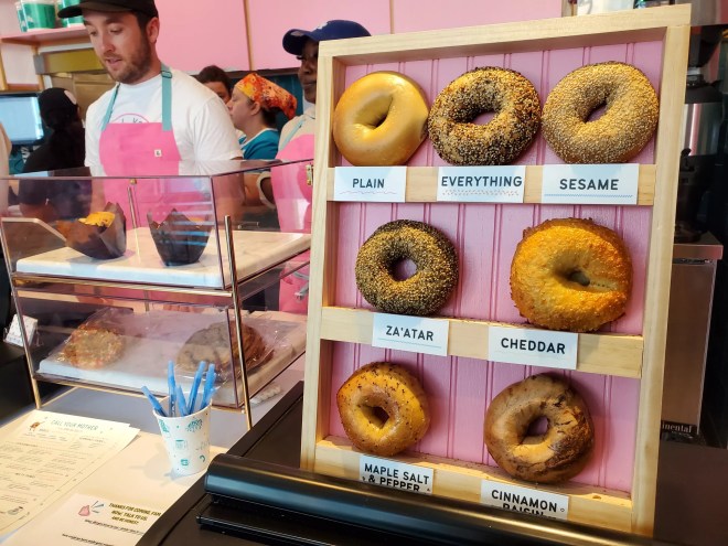 bagels on a vertical display on the counter of a deli