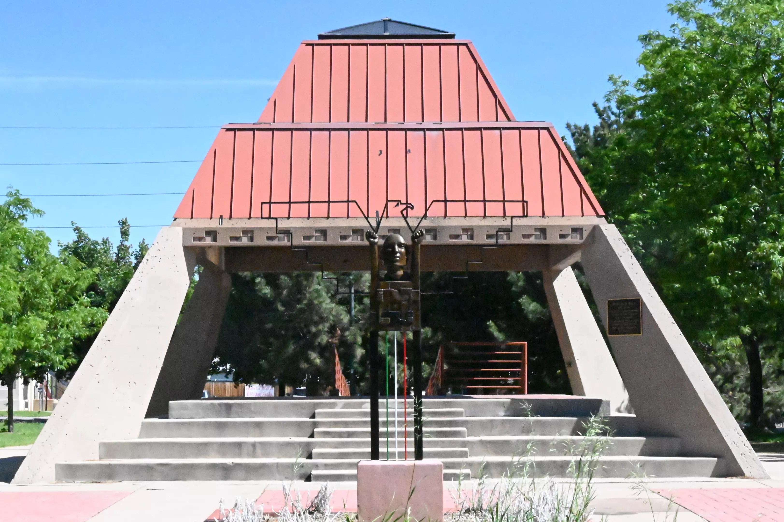 kiosko with Chicano murals in park.