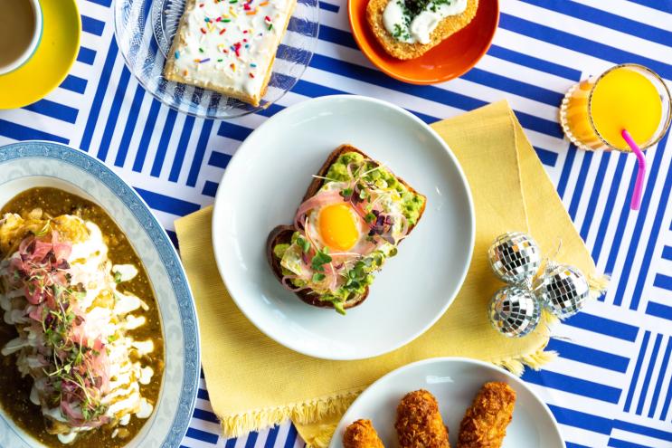 several plates of food on a blue striped table