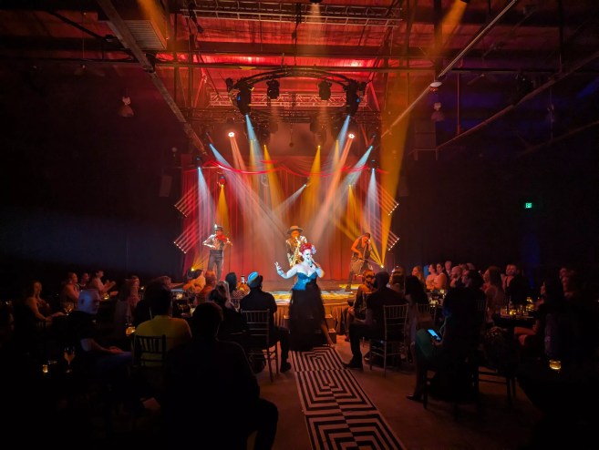 cabaret performers stand on a stage
