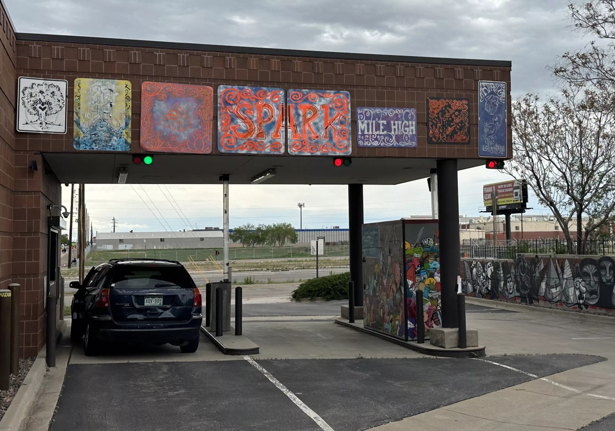 A car parked in a dispensary drive-thru lane