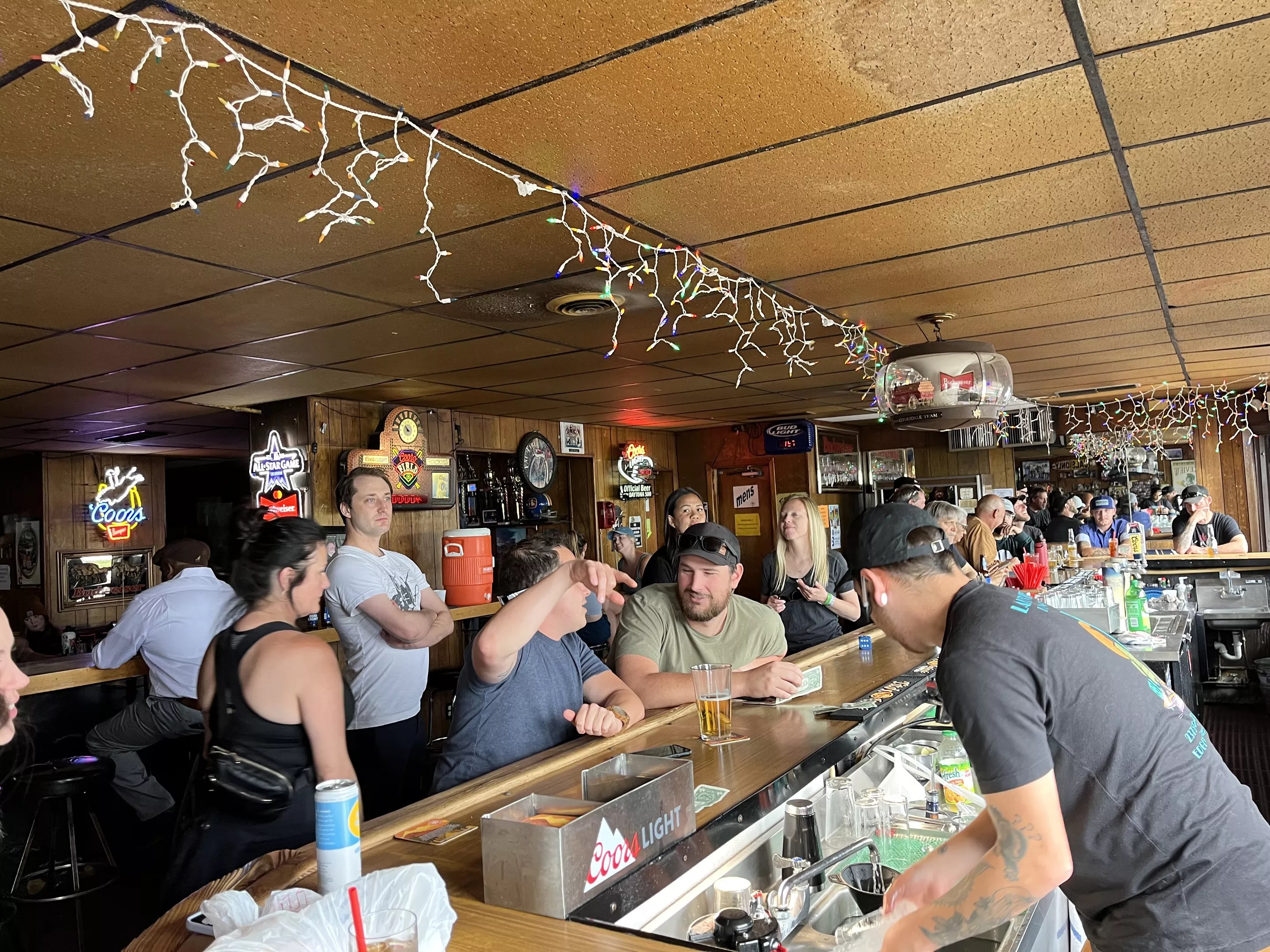 patrons seated at a bar