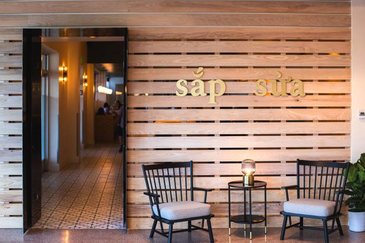 two chairs in front of a wooden wall next to an open entryway
