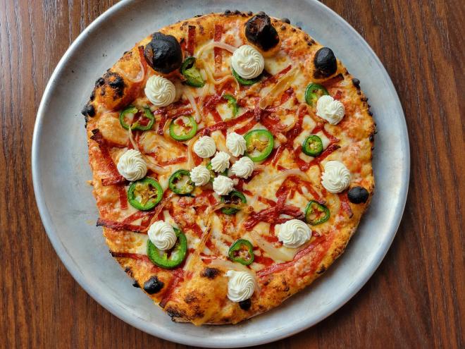 pizza with pepperoni on table
