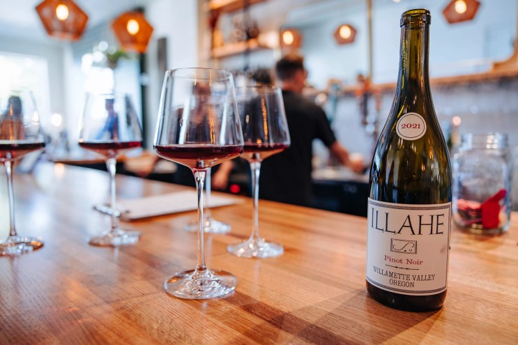glasses of wine and a bottle of wine on a counter