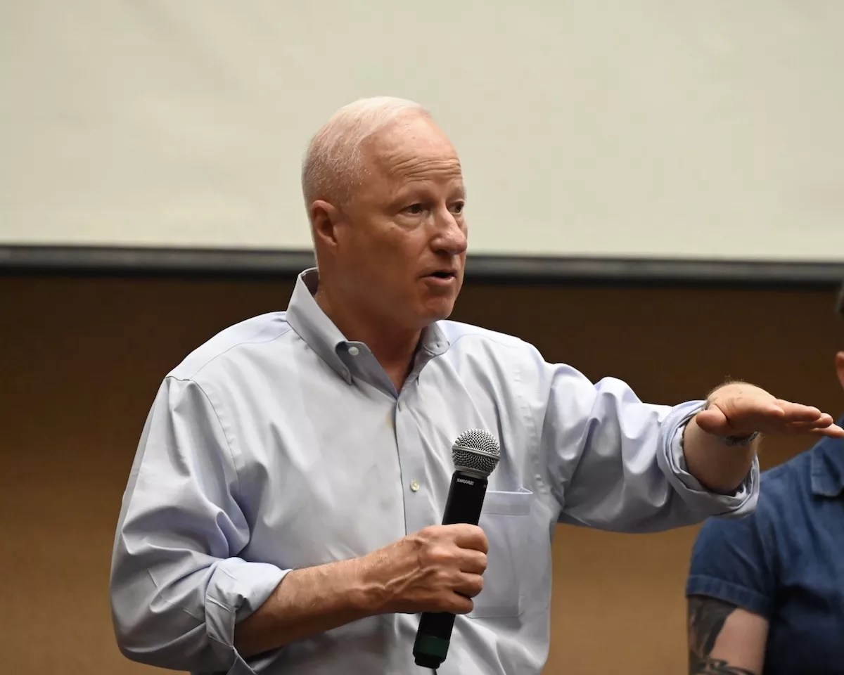 Aurora Mayor Mike Coffman talks to residents at town hall in July.