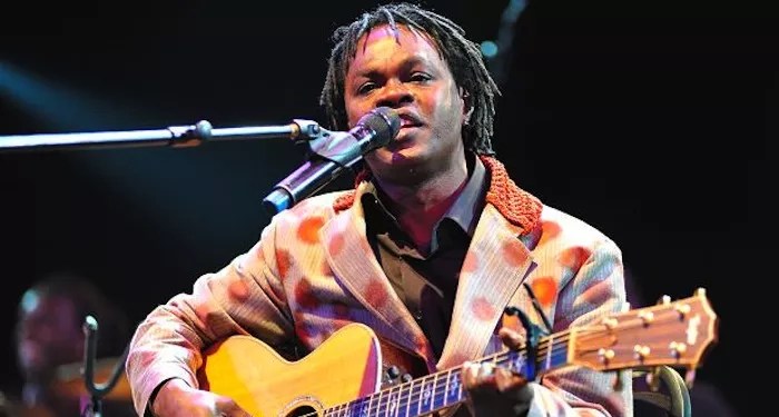 singer on stage with a guitar.