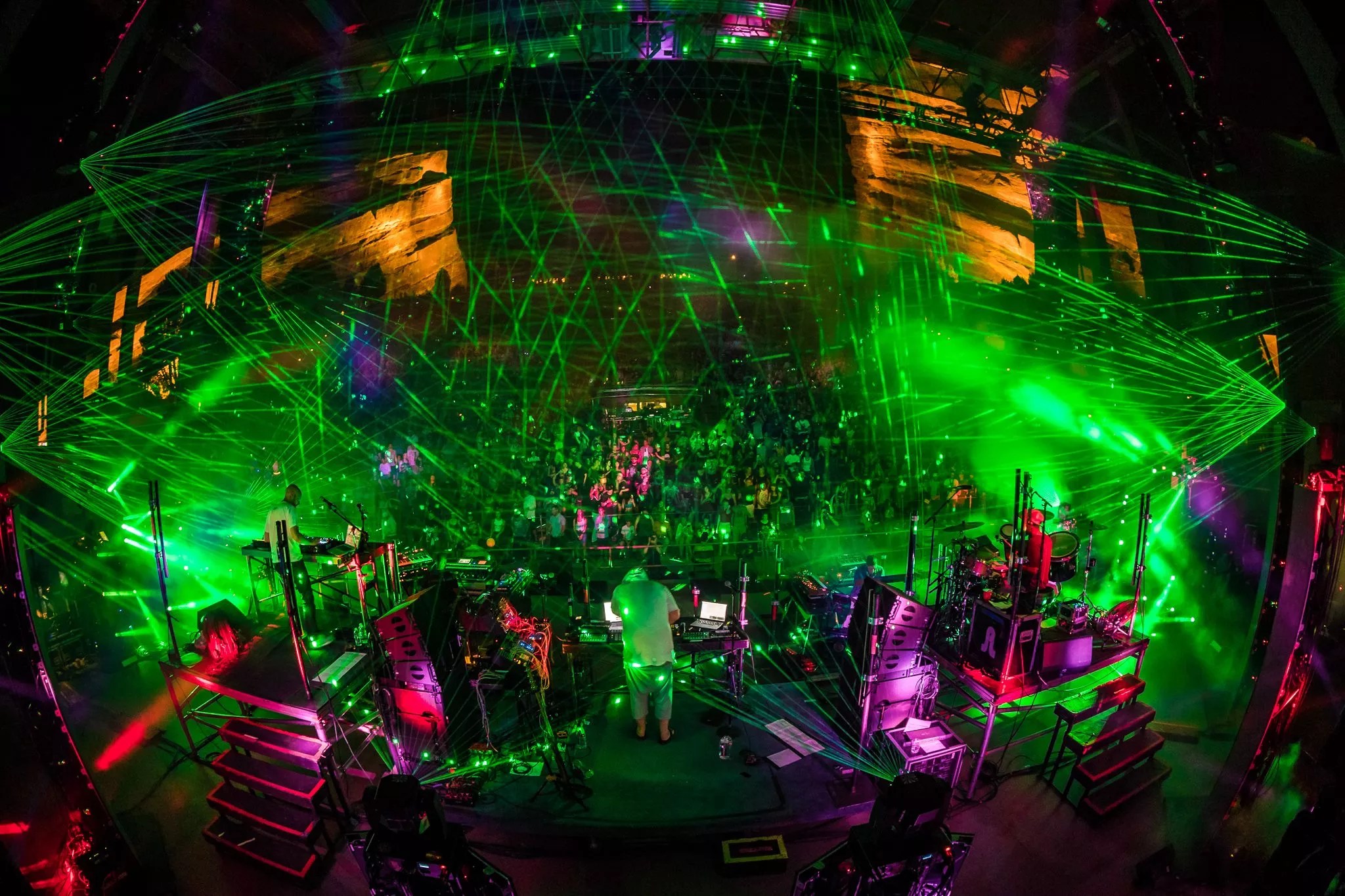 dj performing on stage with a light show