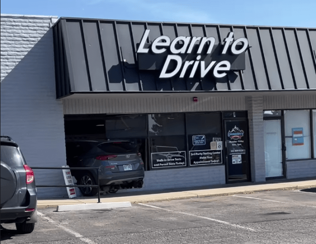 Community Driving School in Lakewood with car through window.