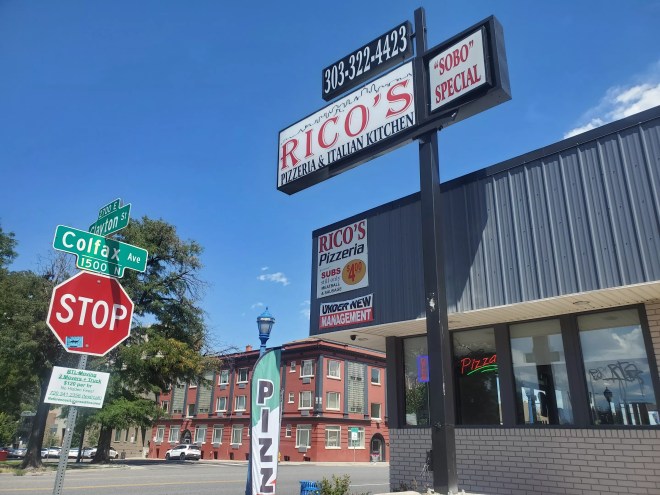 a sign in front of a building