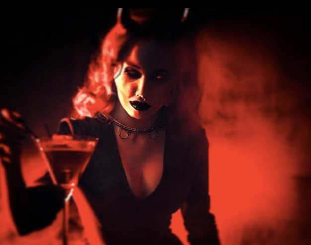 woman with horns holding a cocktail