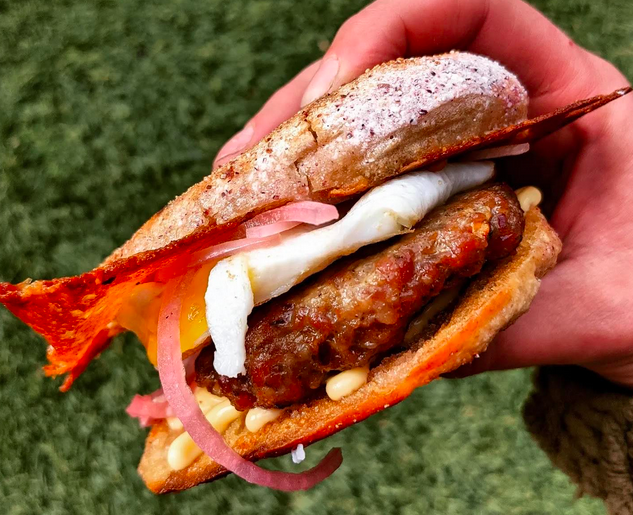 hand holding a breakfast sandwich