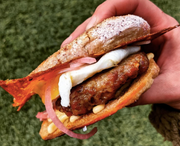 hand holding a breakfast sandwich