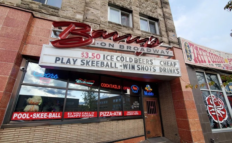 a sign hanging over the entrance to a bar