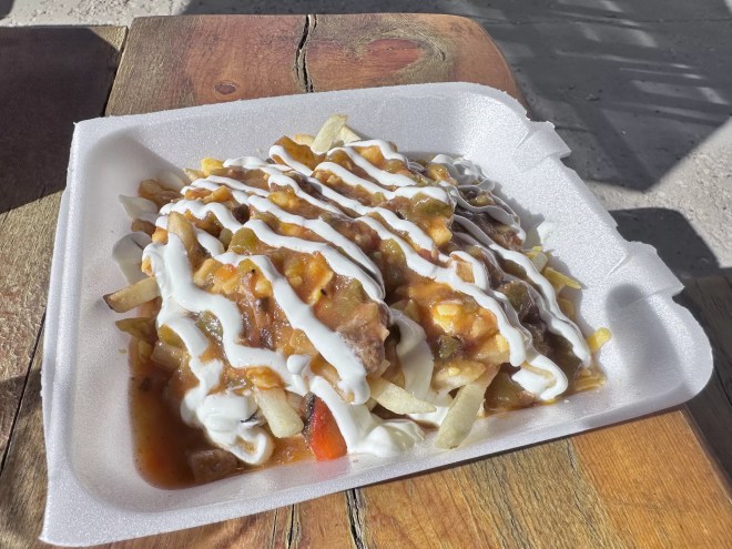 Green Chile smothered fires topped with crema