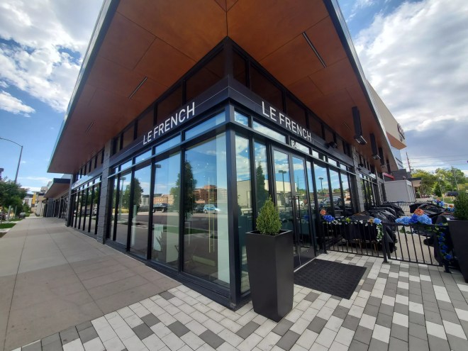 a corner view of a building with glass windows
