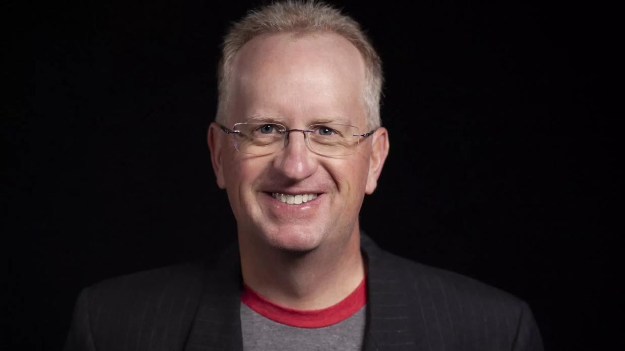man in glasses and t-shirt under blazer