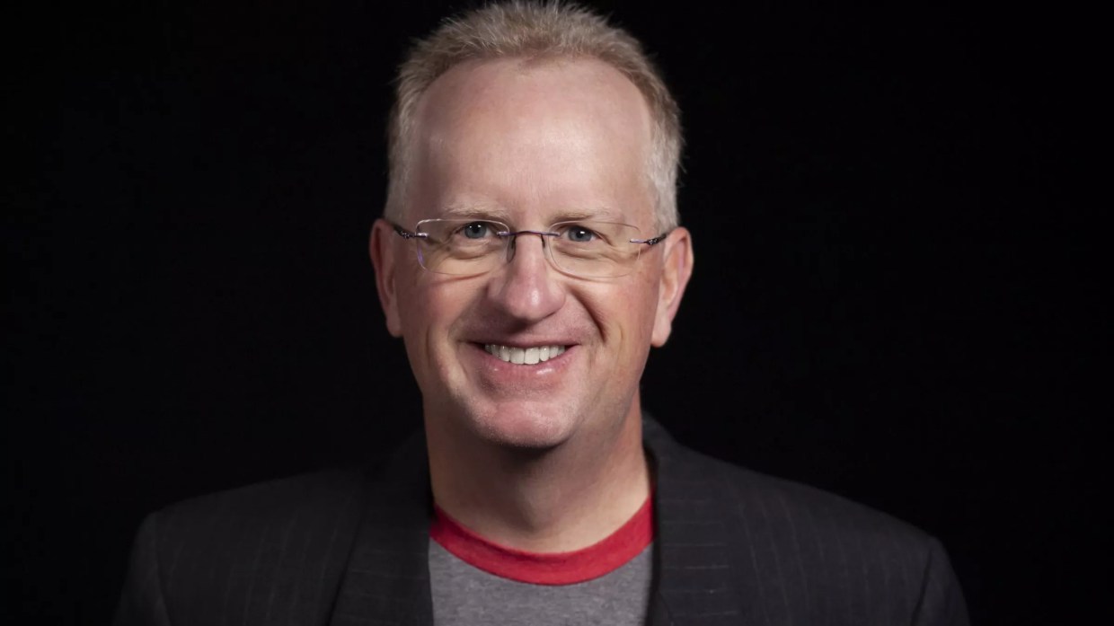 man in glasses and t-shirt under blazer