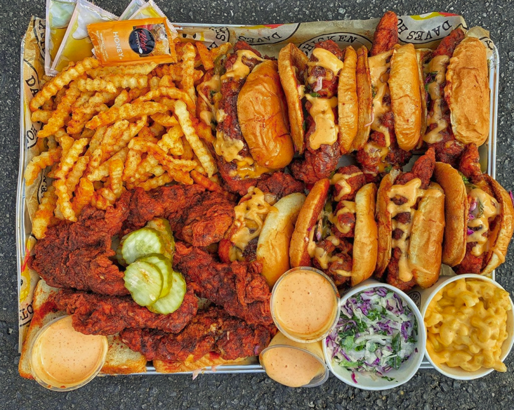 hot chicken sandwiches and tenders on a platter with fries