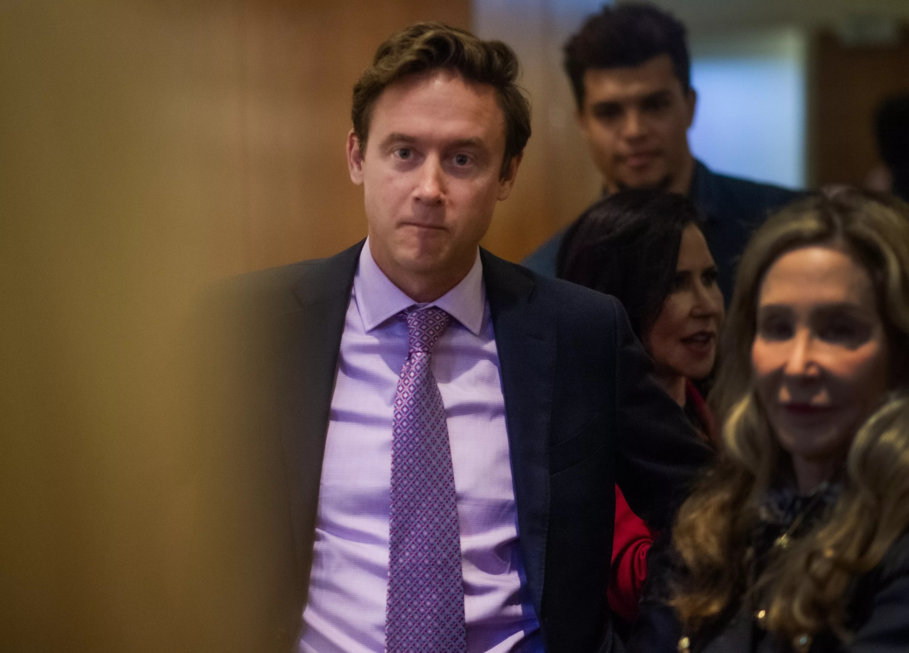 man in pink shirt, purple tie