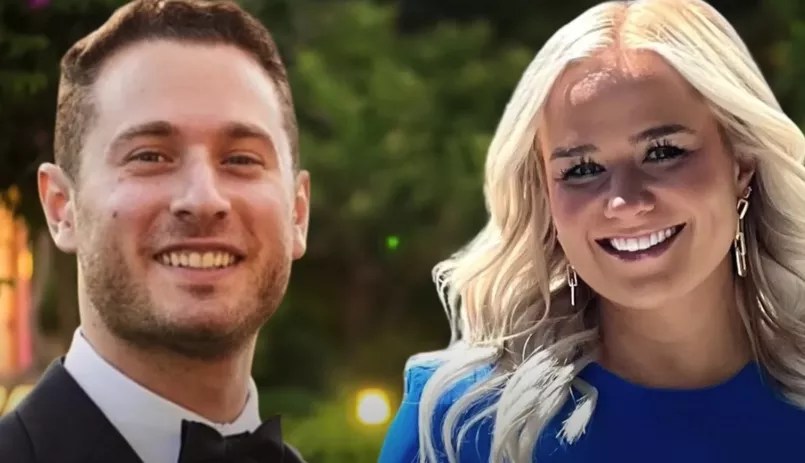 white guy in suit and blonde woman in blue shirt