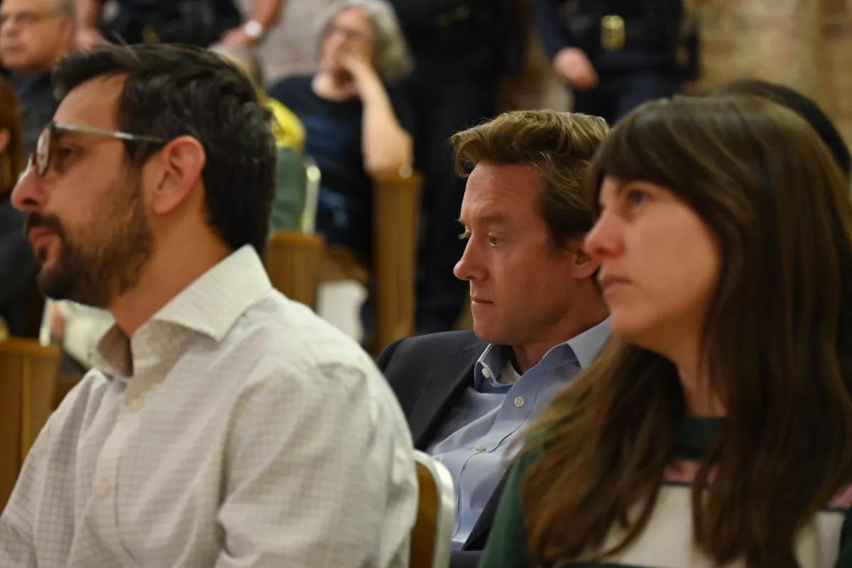 Mayor Mike Johnston sits in the crowd.