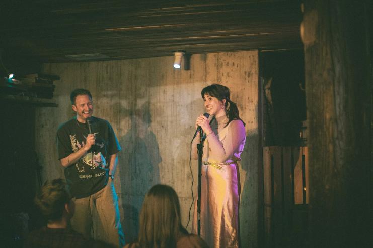 standup comics performing in a room