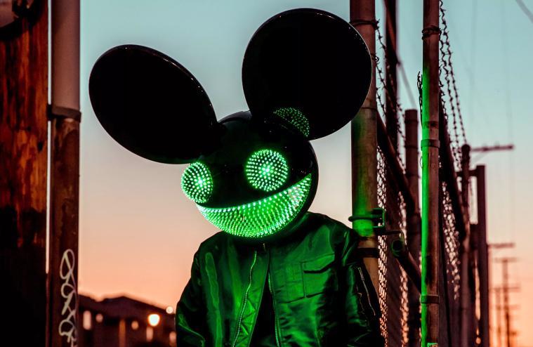 man deejaying in mouse mask