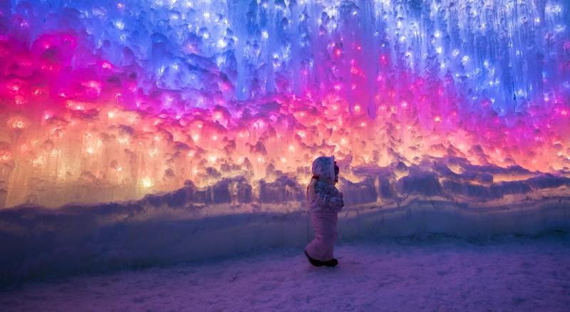 Child exploring Ice Castles at night