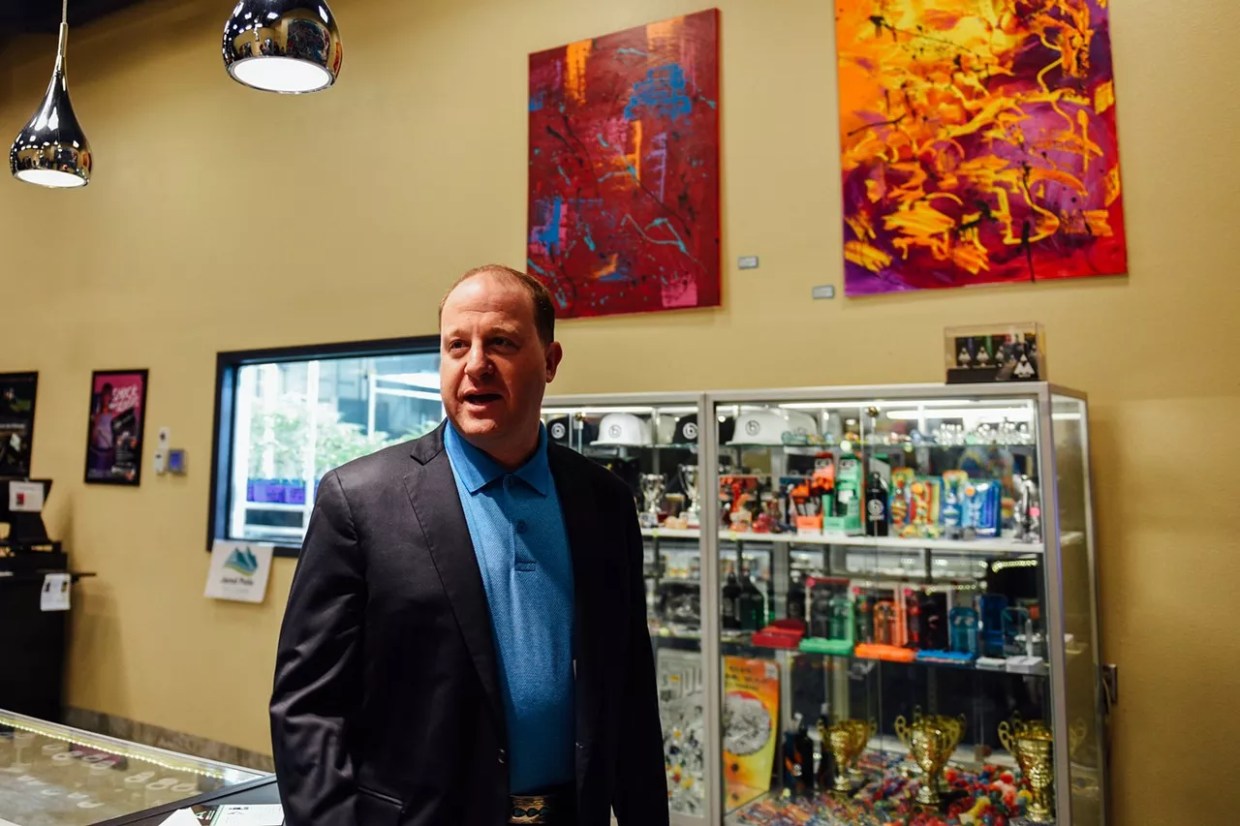 Colorado Governor Jared Polis inside of a marijuana dispensary