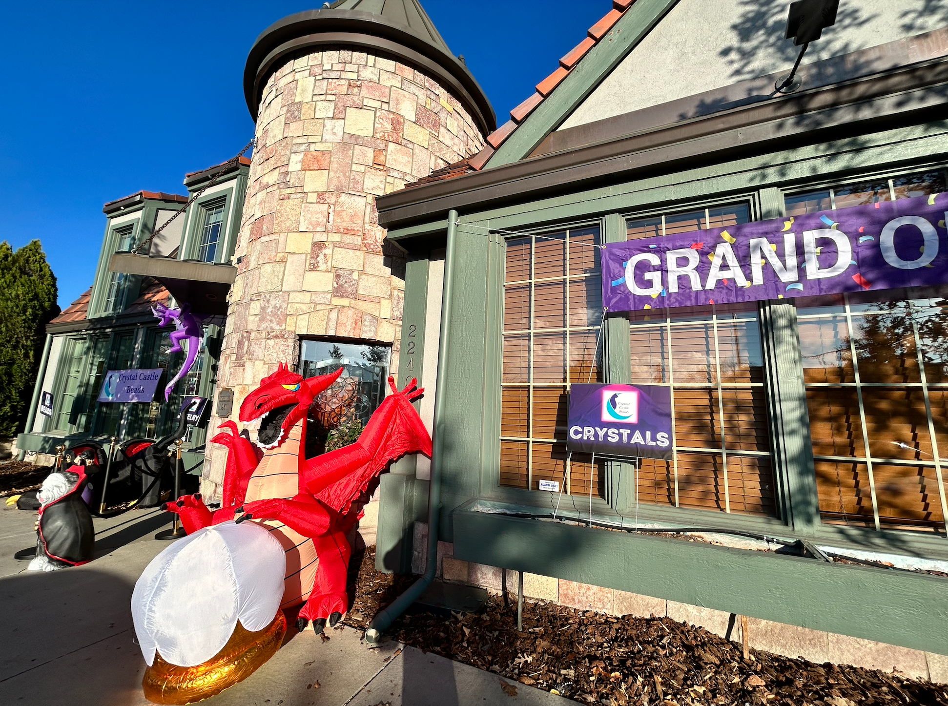 a storefront with an inflatable red dragon outside