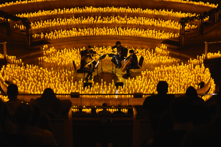 musicians playing instruments surrounded by candles