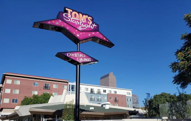pink diner sign against sky.