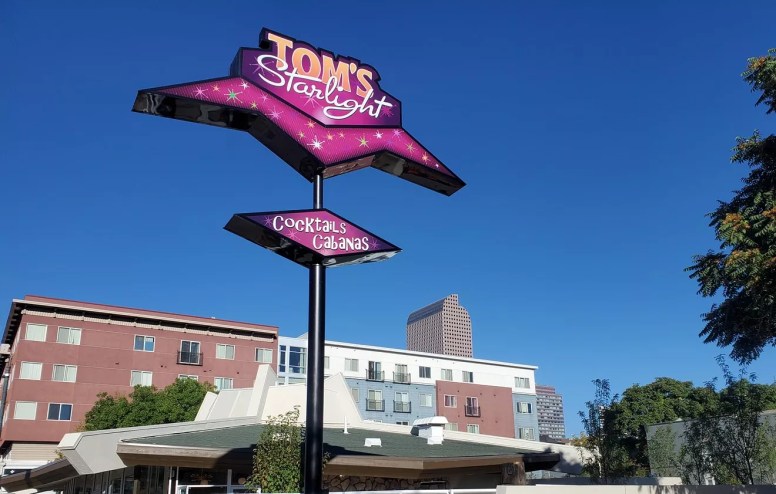 pink diner sign against sky.