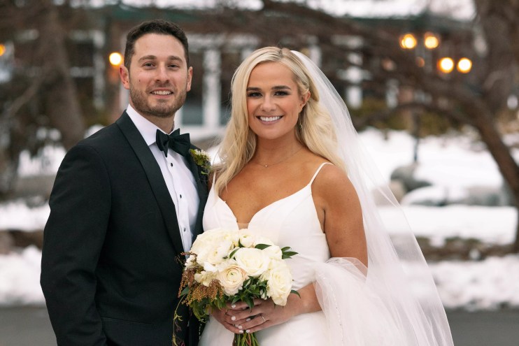Emily and Brennan pose for a wedding portrait.