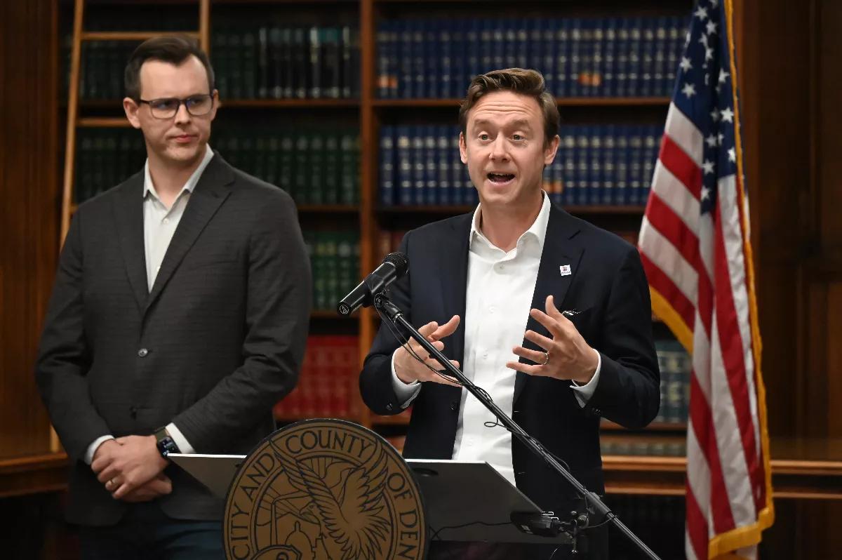Mayor Mike Johnston and Will Goodale from Housing Connector speak at a press conference.