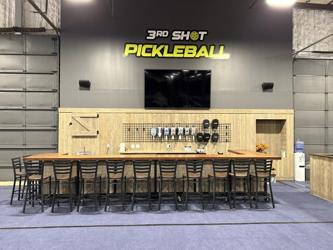 stools lined up in front of a large table indoors