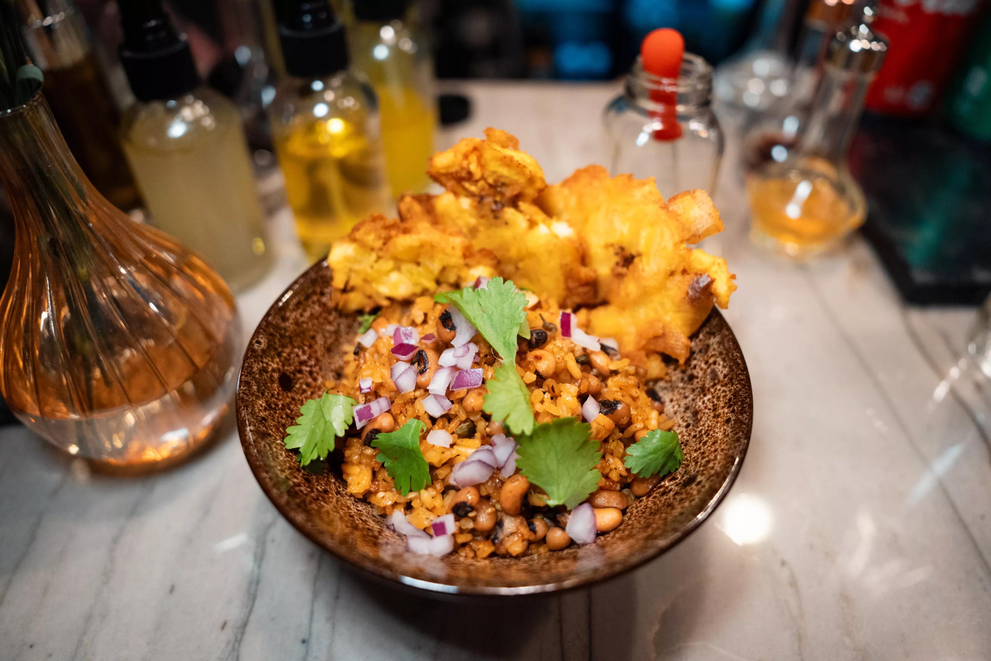 rice garnished with red onions and cilantro