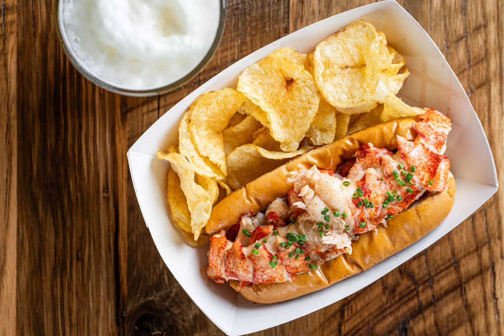 lobster roll in paper baskets on wood table