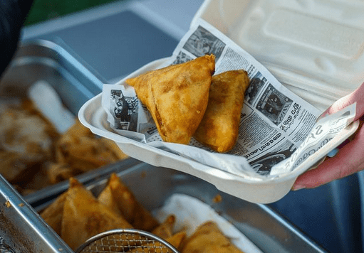two samosas in a to go box