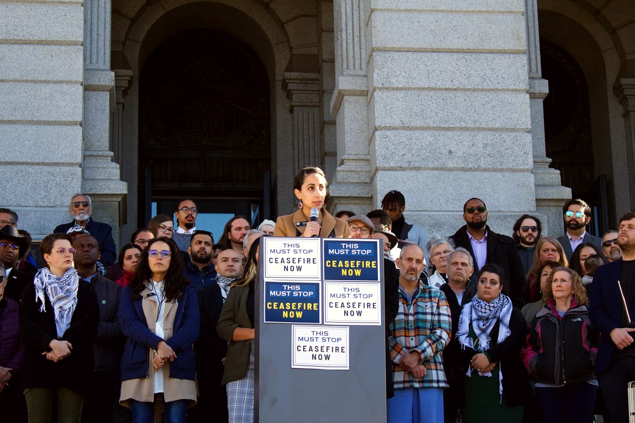 woman at podium at Colorado Capitol while people listen.